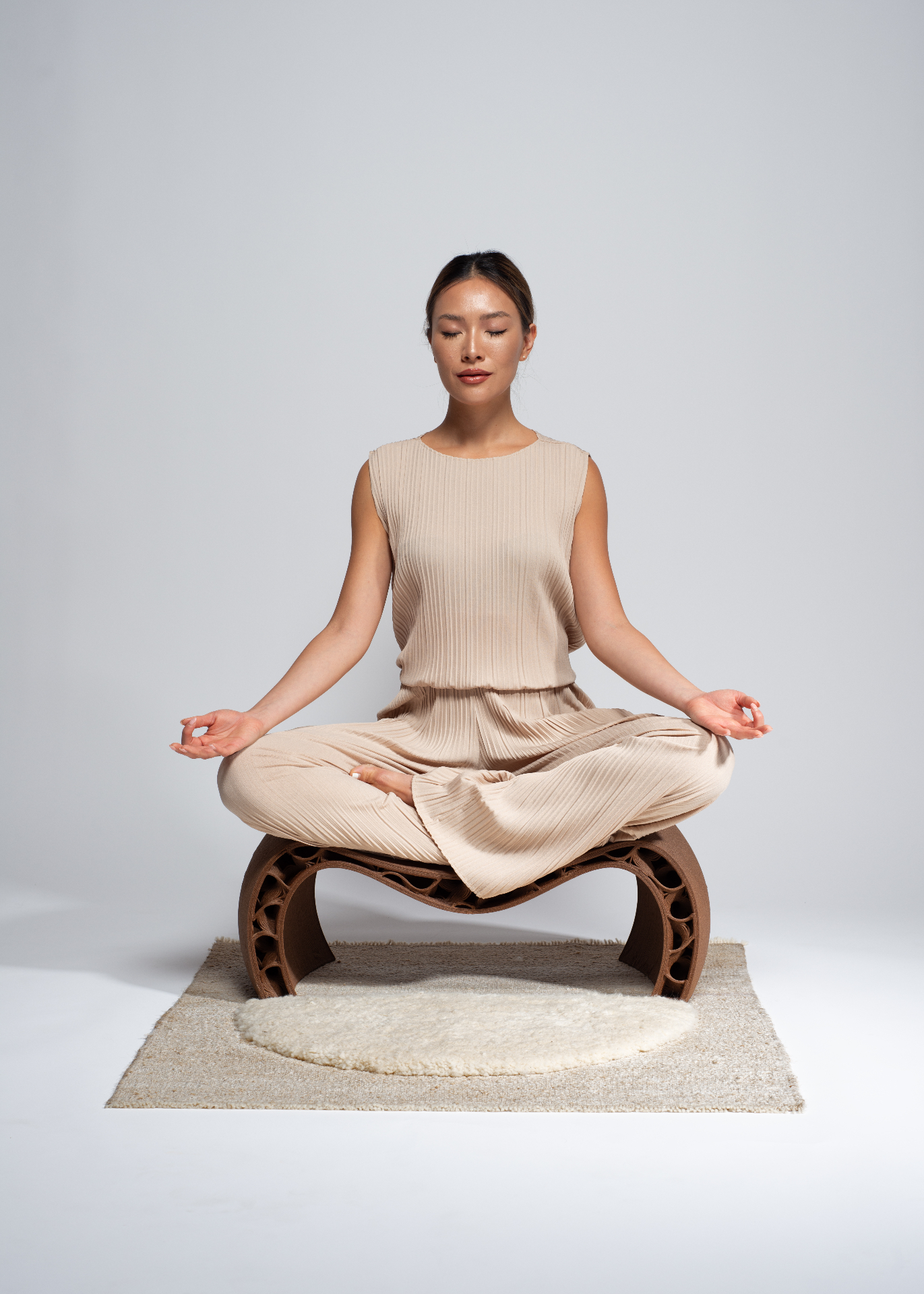 A woman meditating on a HEMPLA seat